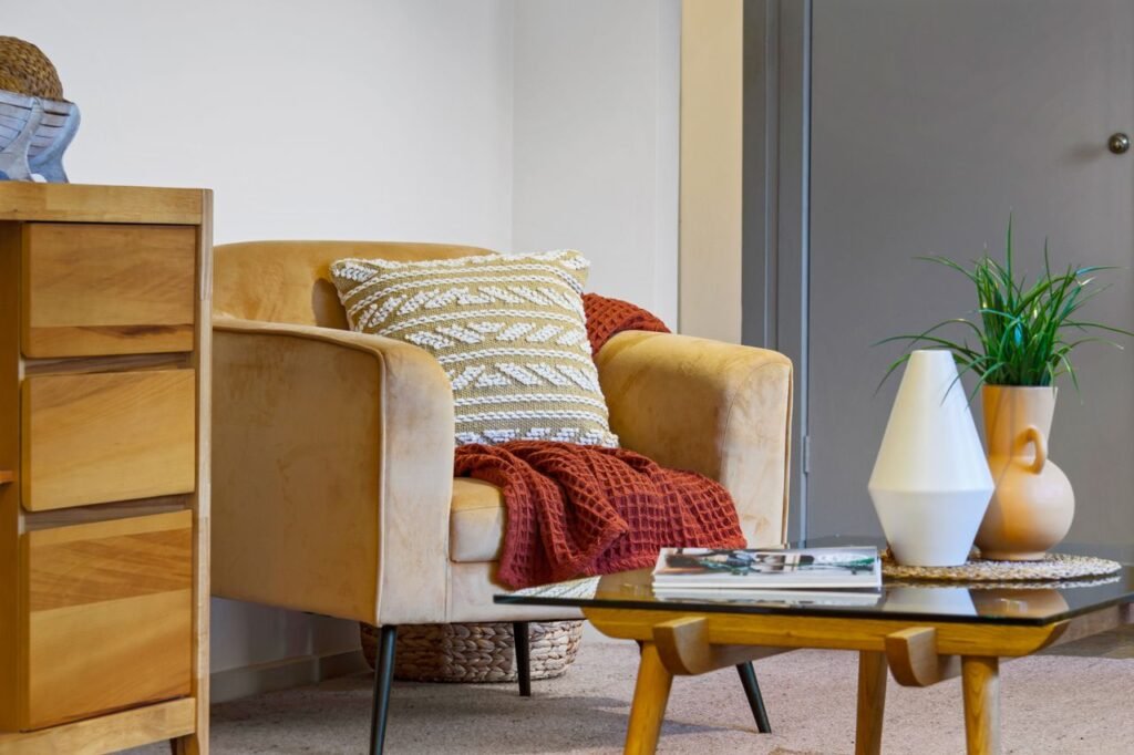 Modern interior featuring a comfy armchair, decorative pillow, and indoor plants.
